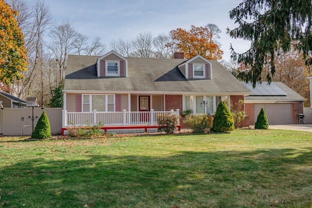 cape cod house featuring solar panels, a garage, covered porch, and a front yard