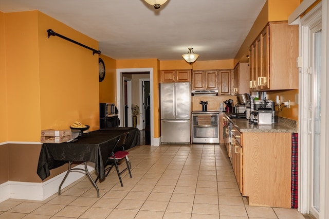 kitchen with light tile patterned floors and appliances with stainless steel finishes