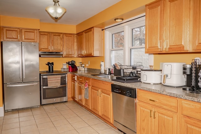 kitchen featuring ventilation hood, light tile patterned flooring, and appliances with stainless steel finishes