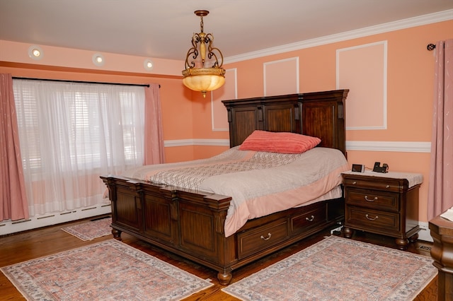 bedroom featuring a baseboard heating unit, dark hardwood / wood-style floors, and crown molding