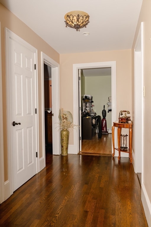 hallway with dark hardwood / wood-style flooring