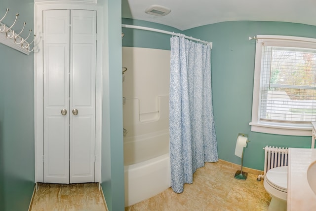 bathroom with radiator heating unit, shower / bathtub combination with curtain, and toilet