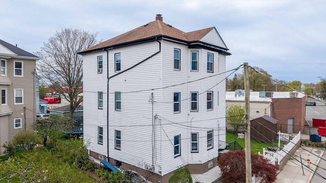 view of home's exterior with fence