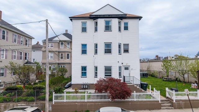 view of front facade featuring fence private yard and central AC