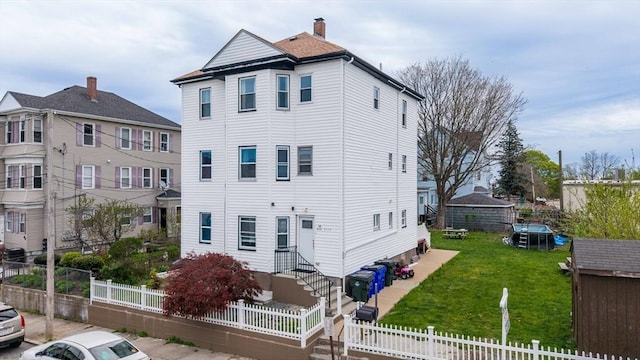 view of front of house with a fenced front yard and a front yard