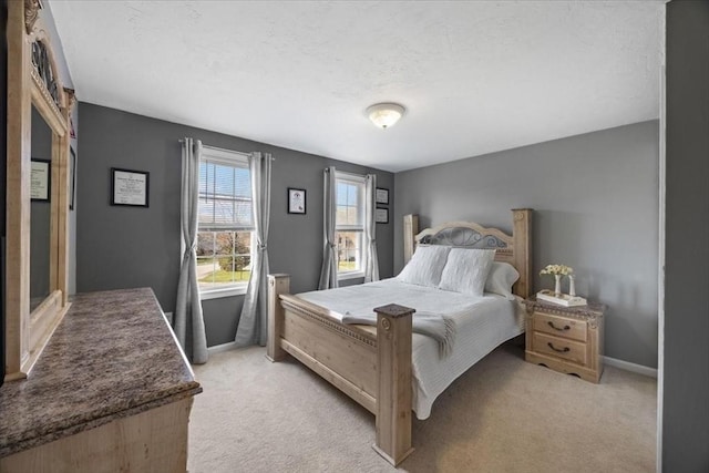 bedroom featuring baseboards and light carpet