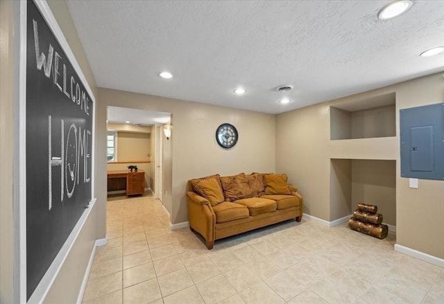 living area with electric panel, a textured ceiling, light tile patterned floors, baseboards, and recessed lighting