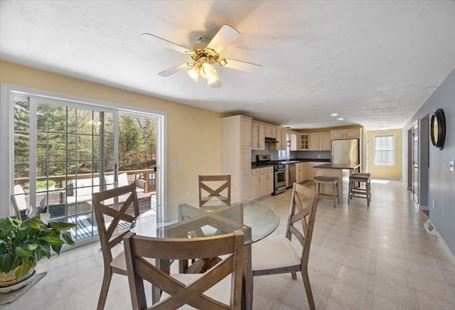 dining room featuring a ceiling fan and baseboards
