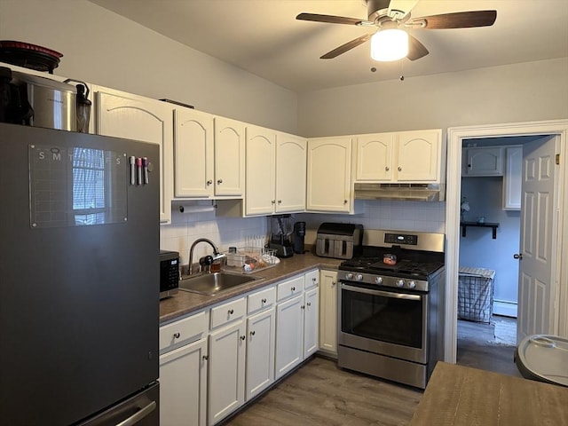 808 Walnut St, Fall River, MA 02720 - kitchen featuring baseboard heating, under cabinet range hood, ceiling fan, a sink, and appliances with stainless steel finishes