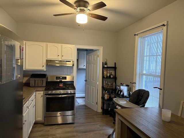 808 Walnut St, Fall River, MA 02720 - kitchen with under cabinet range hood, ceiling fan, gas range, dark wood-type flooring, and white cabinets