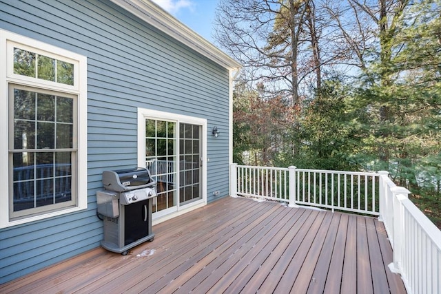 wooden deck featuring a grill