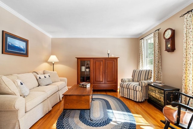 living area with crown molding and light wood-style floors