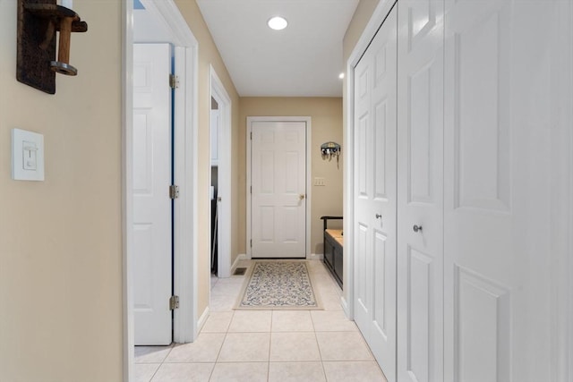 hall with light tile patterned floors, recessed lighting, and baseboards