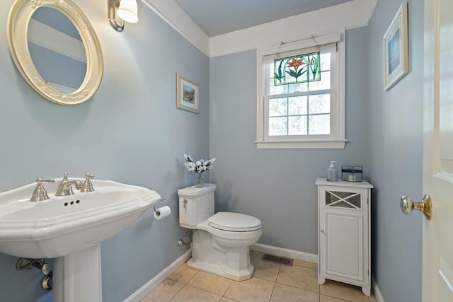 bathroom featuring tile patterned flooring, visible vents, toilet, and baseboards