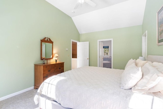 bedroom with ensuite bath, carpet, baseboards, ceiling fan, and vaulted ceiling