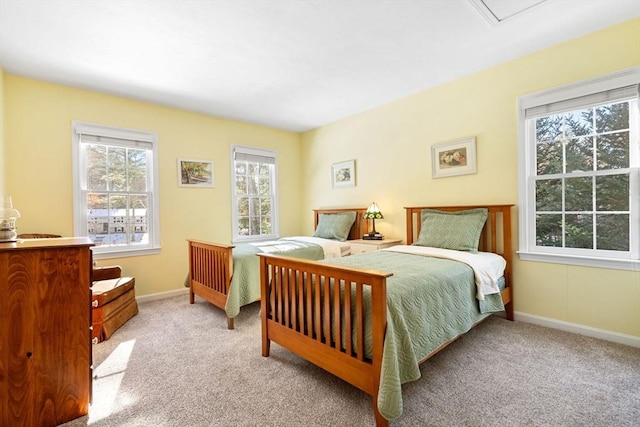 bedroom with baseboards and carpet