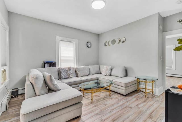 living area with light wood-type flooring and baseboard heating