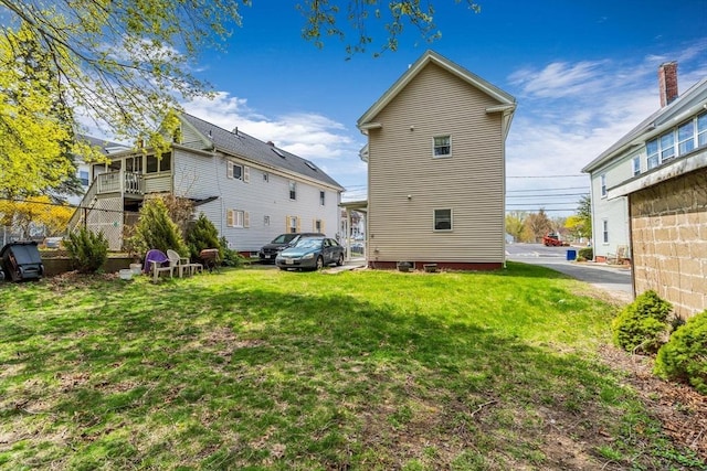 rear view of property with a yard