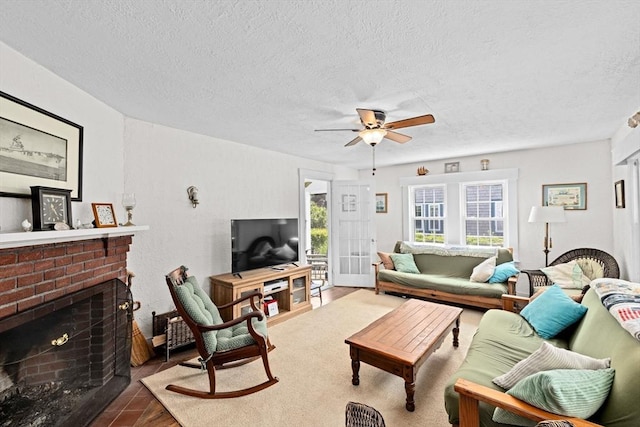 590 Hatherly Rd, Scituate, MA 02066 - living room featuring wood finished floors, a ceiling fan, a textured ceiling, and a fireplace