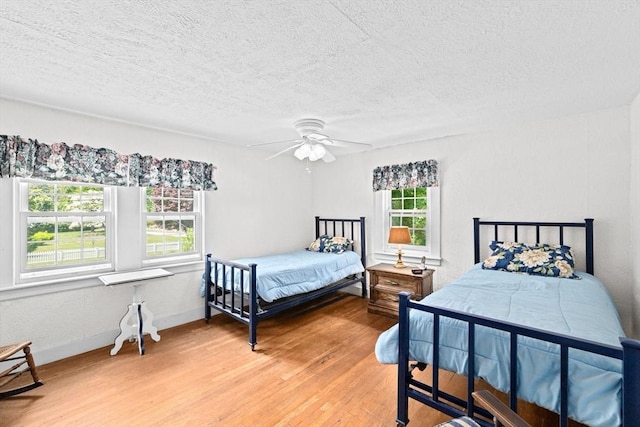 590 Hatherly Rd, Scituate, MA 02066 - bedroom with light wood-type flooring, a textured ceiling, and a ceiling fan