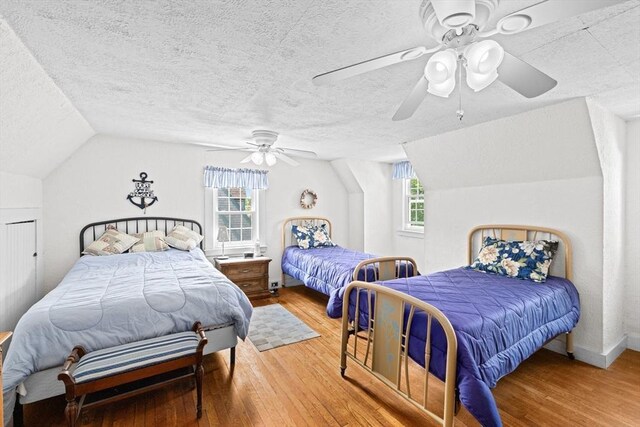 590 Hatherly Rd, Scituate, MA 02066 - bedroom with wood finished floors, lofted ceiling, a textured ceiling, and ceiling fan
