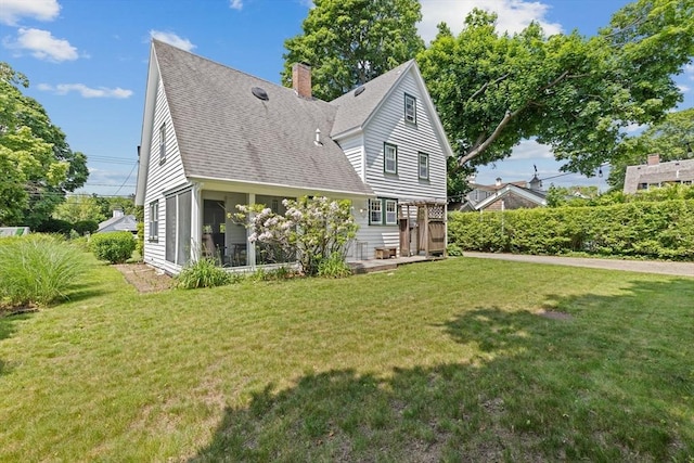 590 Hatherly Rd, Scituate, MA 02066 - view of front of house featuring a front yard, roof with shingles, a chimney, and a sunroom