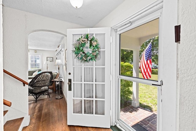 590 Hatherly Rd, Scituate, MA 02066 - entryway featuring a textured wall, arched walkways, wood finished floors, stairway, and a textured ceiling