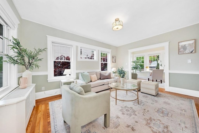 living area with light wood-style floors and baseboards