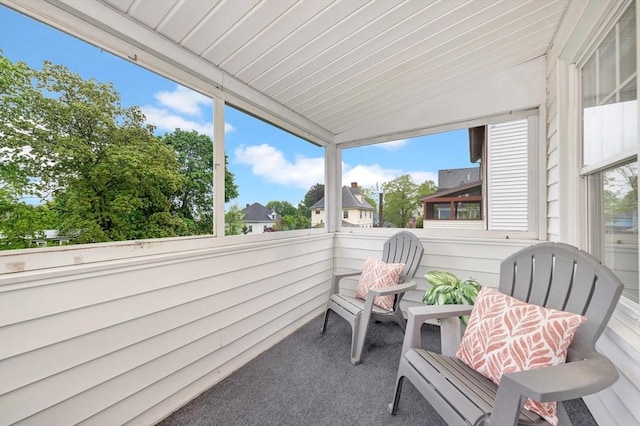 sunroom with vaulted ceiling and healthy amount of natural light
