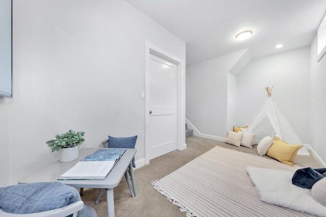 bedroom featuring light carpet and baseboards