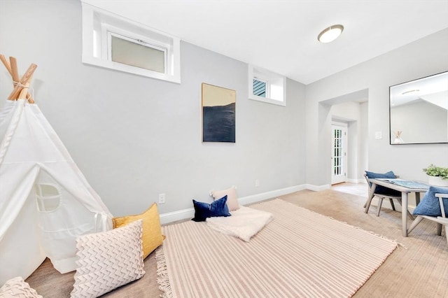 sitting room with baseboards and carpet