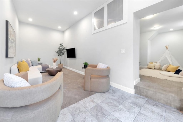 carpeted living area with baseboards and recessed lighting