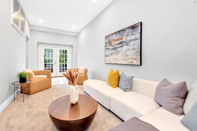living area featuring french doors, recessed lighting, baseboards, and light carpet