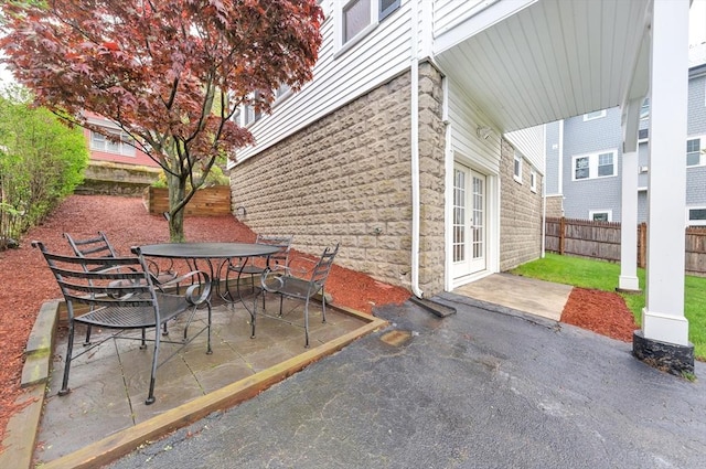 view of patio / terrace featuring outdoor dining area, a fenced backyard, and french doors