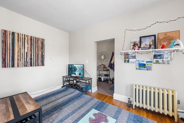 115 Elm St, Somerville, MA 02144 - bedroom featuring radiator heating unit, wood finished floors, and baseboards