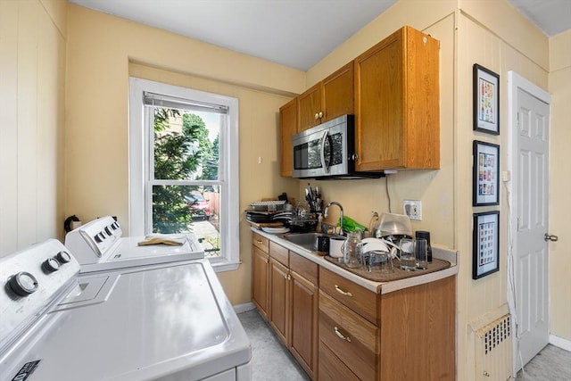 115 Elm St, Somerville, MA 02144 - laundry room featuring separate washer and dryer and baseboards