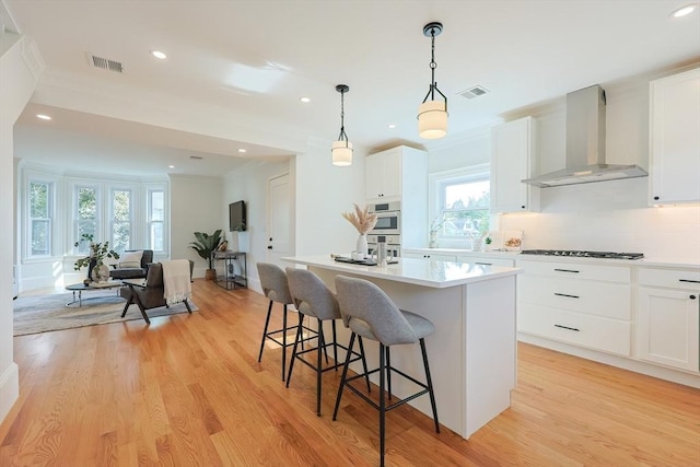 179 Main Unit 2, Medford, MA 02155 - kitchen featuring wall chimney exhaust hood, gas stovetop, healthy amount of natural light, light wood-style floors, and recessed lighting
