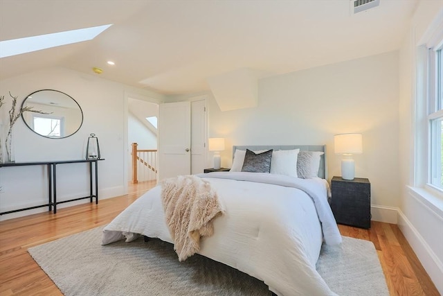 179 Main Unit 2, Medford, MA 02155 - bedroom featuring light wood-type flooring, a skylight, baseboards, lofted ceiling, and recessed lighting
