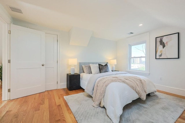179 Main Unit 2, Medford, MA 02155 - bedroom featuring light wood-style floors, baseboards, lofted ceiling, and recessed lighting