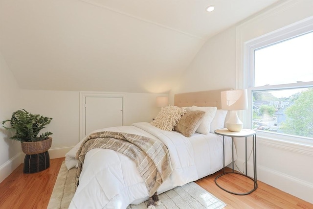 179 Main Unit 2, Medford, MA 02155 - bedroom with lofted ceiling, light wood-style flooring, multiple windows, baseboards, and recessed lighting