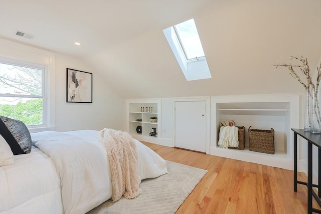 179 Main Unit 2, Medford, MA 02155 - bedroom with a skylight, lofted ceiling, and light wood-type flooring