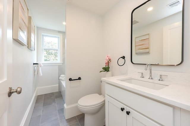 179 Main Unit 2, Medford, MA 02155 - bathroom with toilet, vanity, tile patterned floors, baseboards, and a tub to relax in