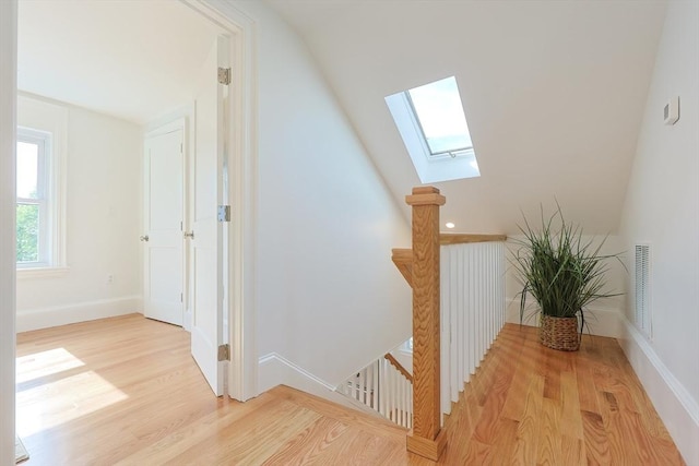 179 Main Unit 2, Medford, MA 02155 - stairs with a skylight, wood finished floors, and baseboards