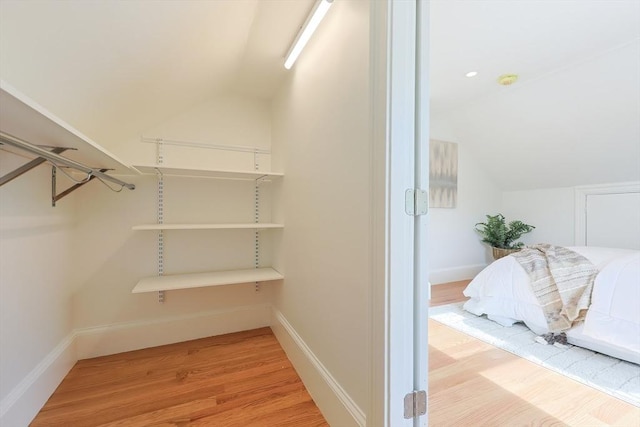 179 Main Unit 2, Medford, MA 02155 - walk in closet featuring lofted ceiling and wood finished floors