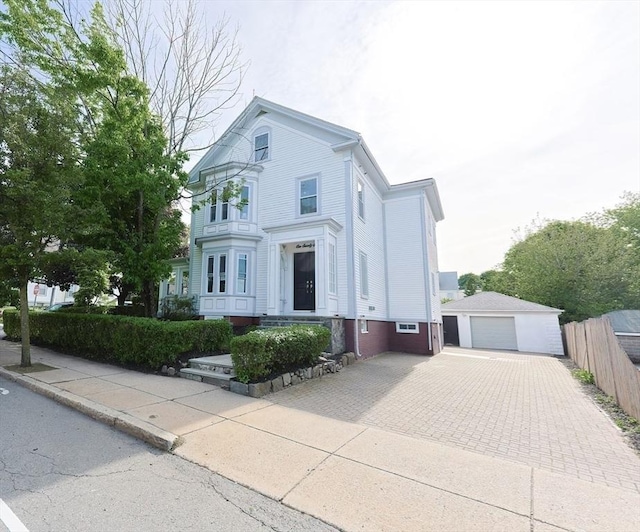 179 Main Unit 2, Medford, MA 02155 - view of front facade with a detached garage, an outbuilding, and driveway