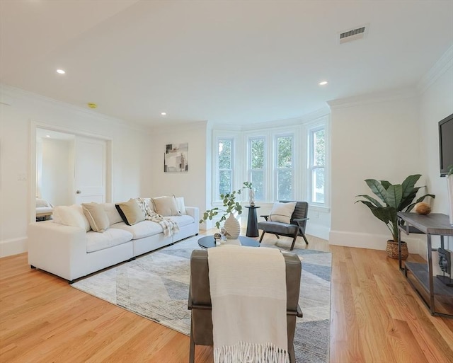 179 Main Unit 2, Medford, MA 02155 - living area with crown molding, baseboards, light wood finished floors, and recessed lighting