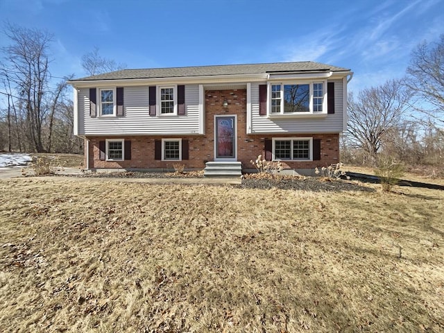 split foyer home with entry steps and brick siding