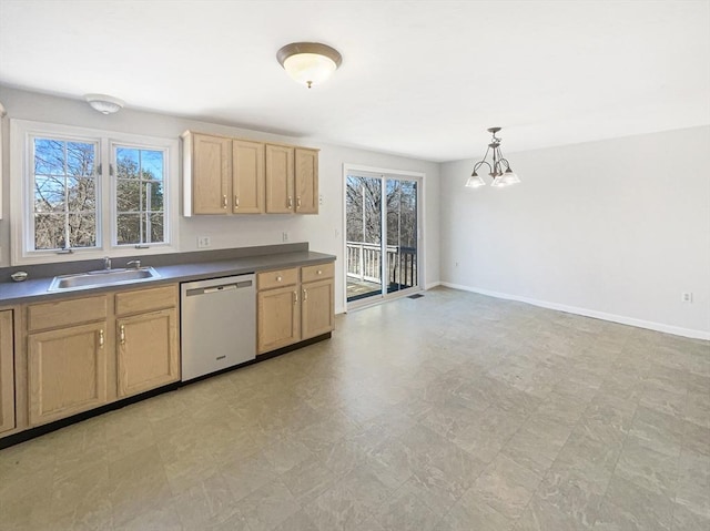 kitchen featuring a sink, dark countertops, dishwasher, and a wealth of natural light