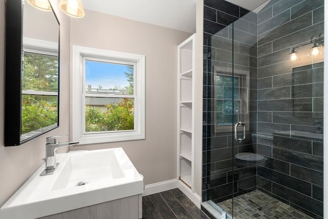 13 Campello Rd, Framingham, MA 01701 - bathroom with vanity, a shower stall, healthy amount of natural light, and wood finished floors