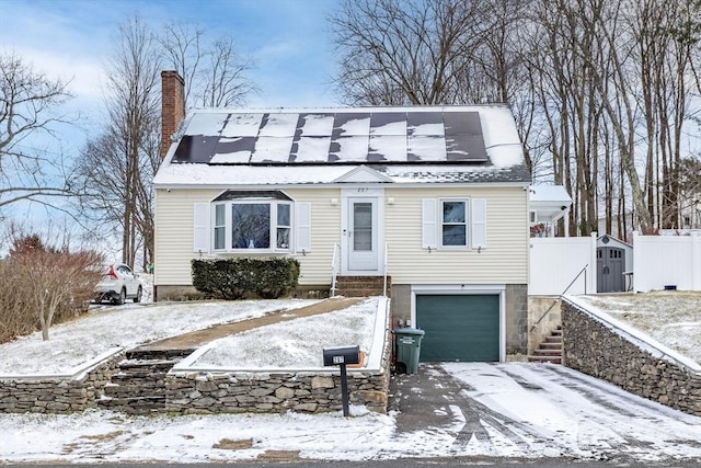 view of front of home featuring solar panels and a garage